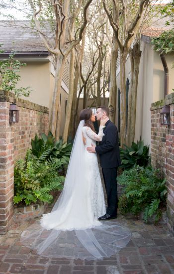a couple kissing in a courtyard