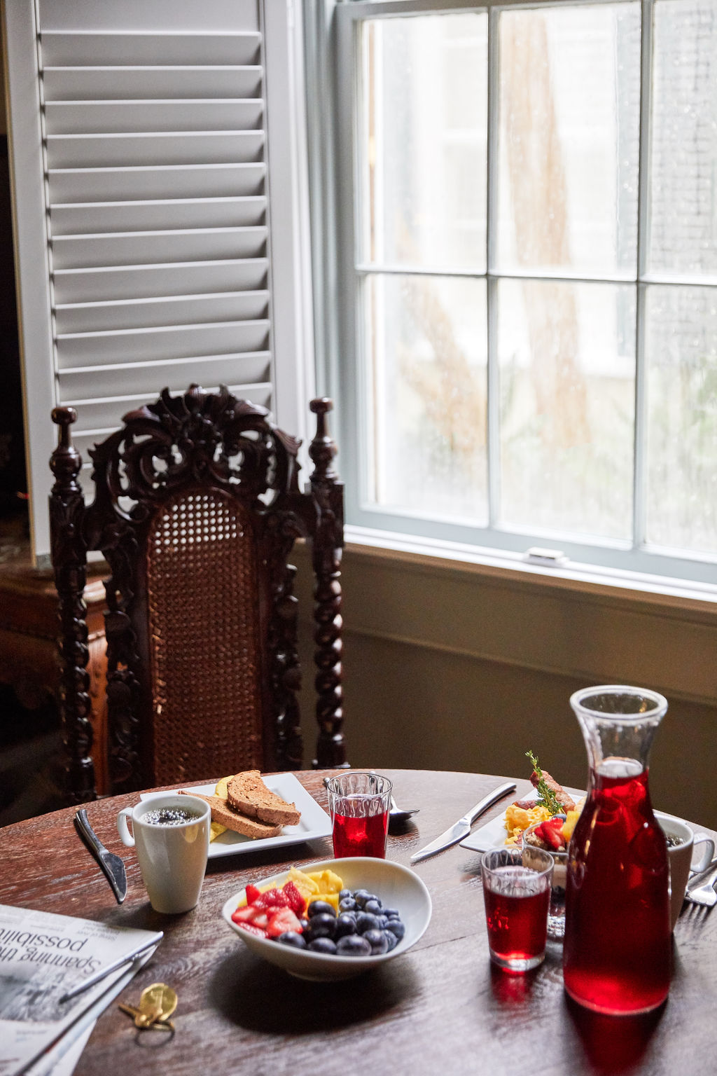 a breakfast table set with food and drink